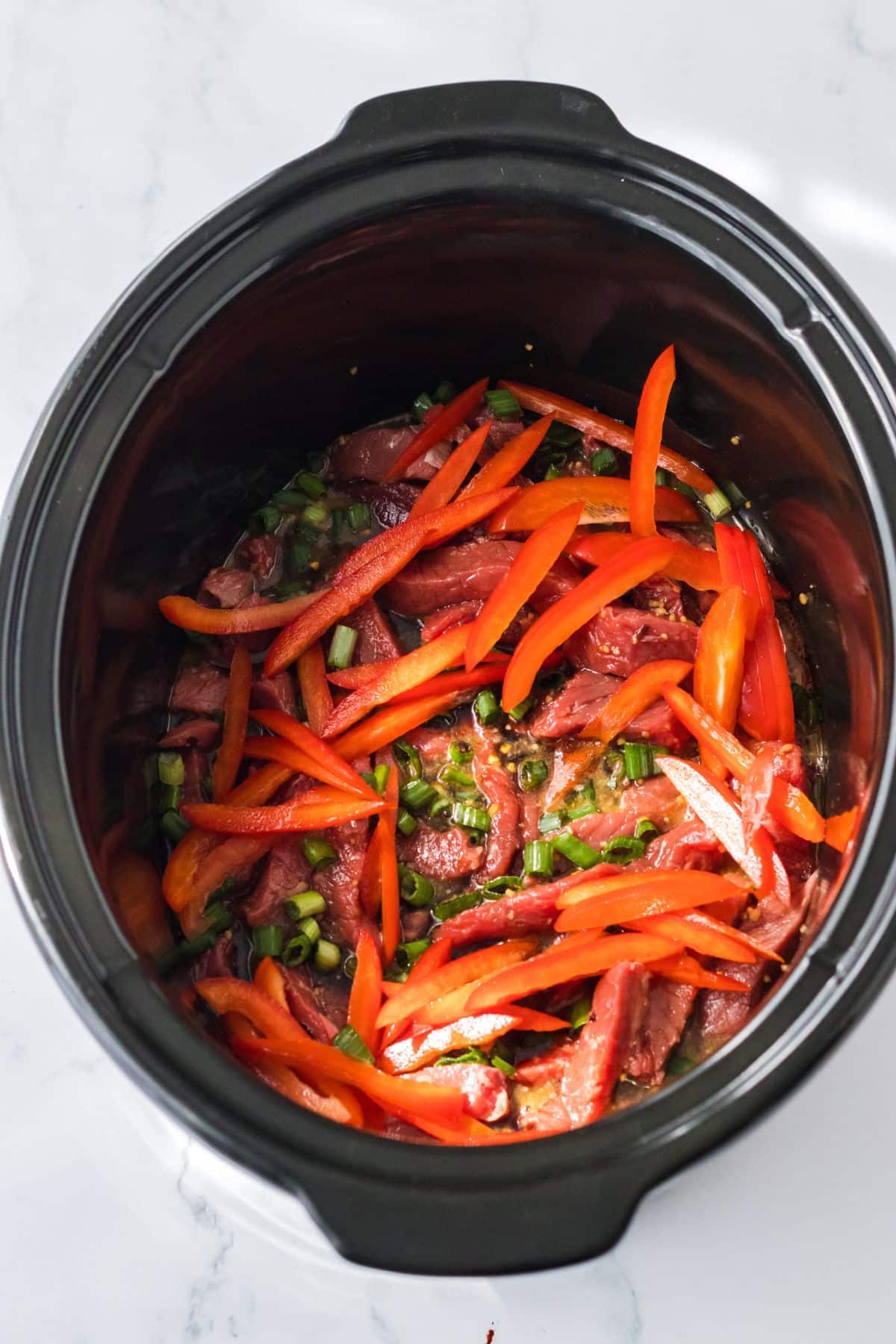 Ingredients being added to the crockpot.