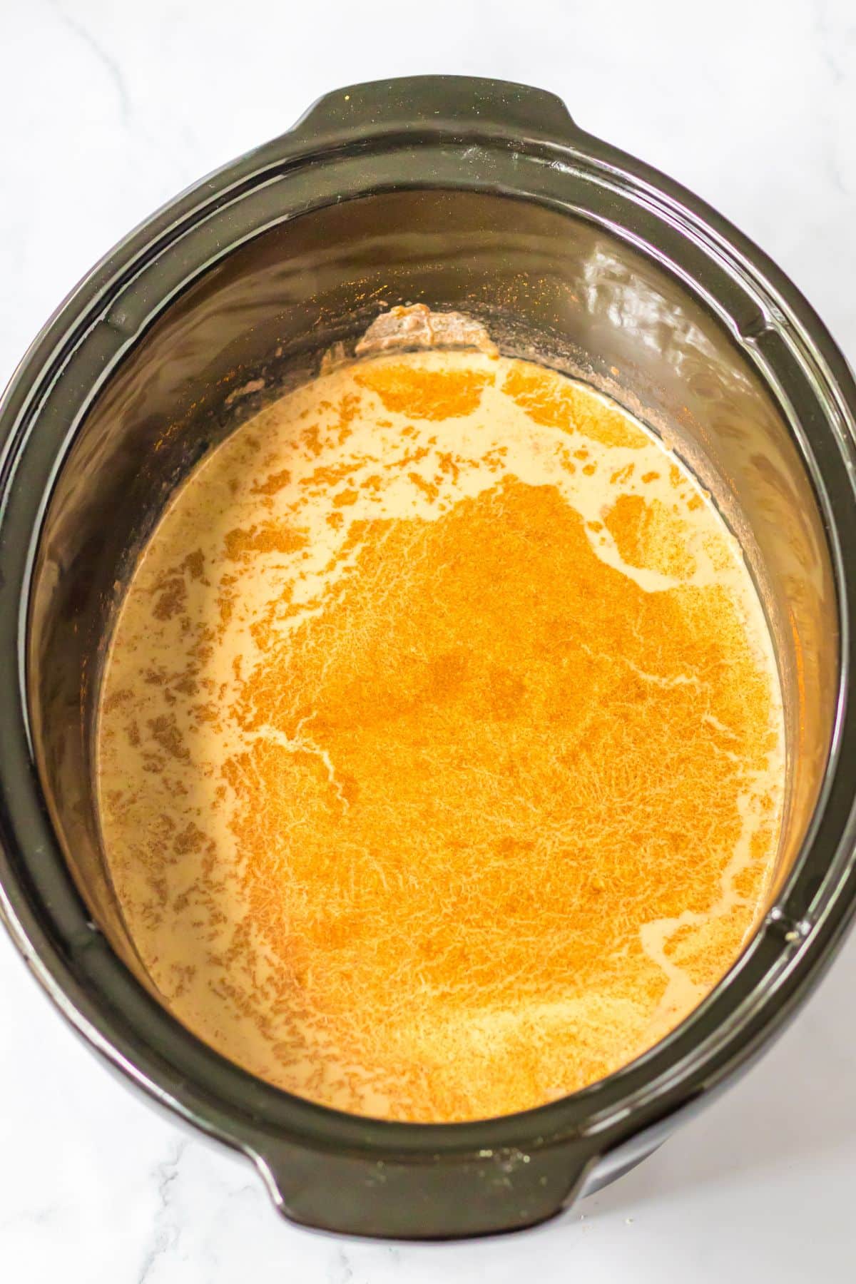 Pumpkin latte being cooked in a slow cooker.