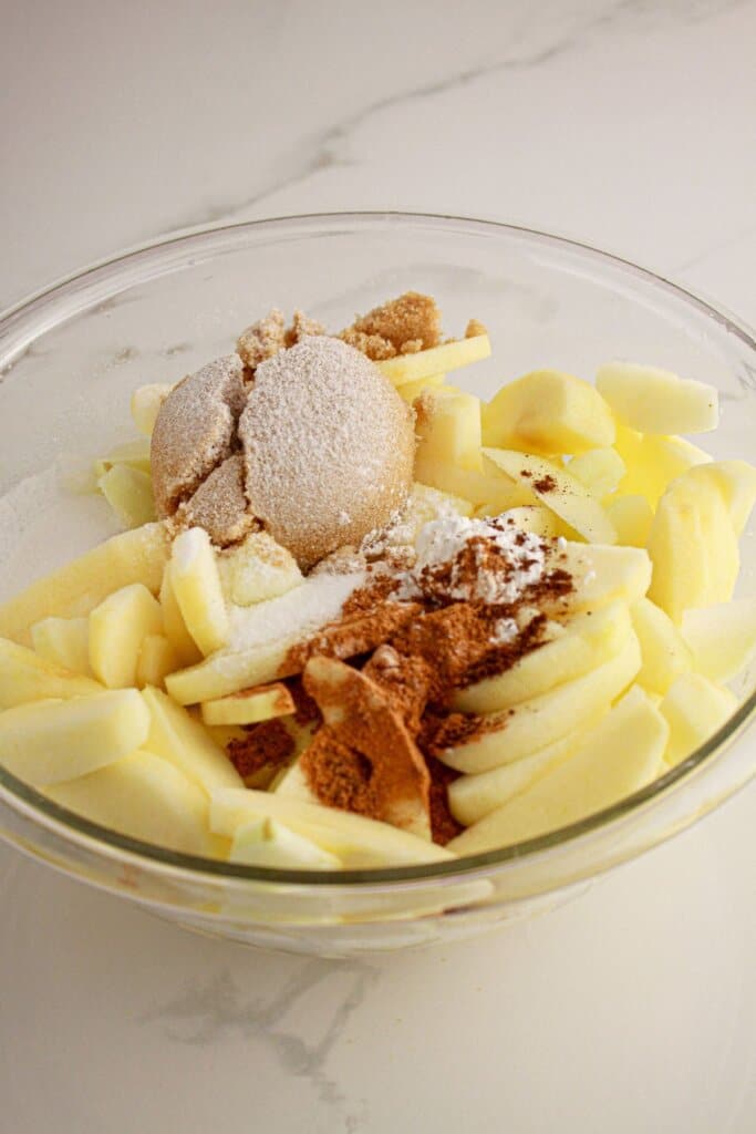 Apples, sugar,cinnamon in a large bowl.