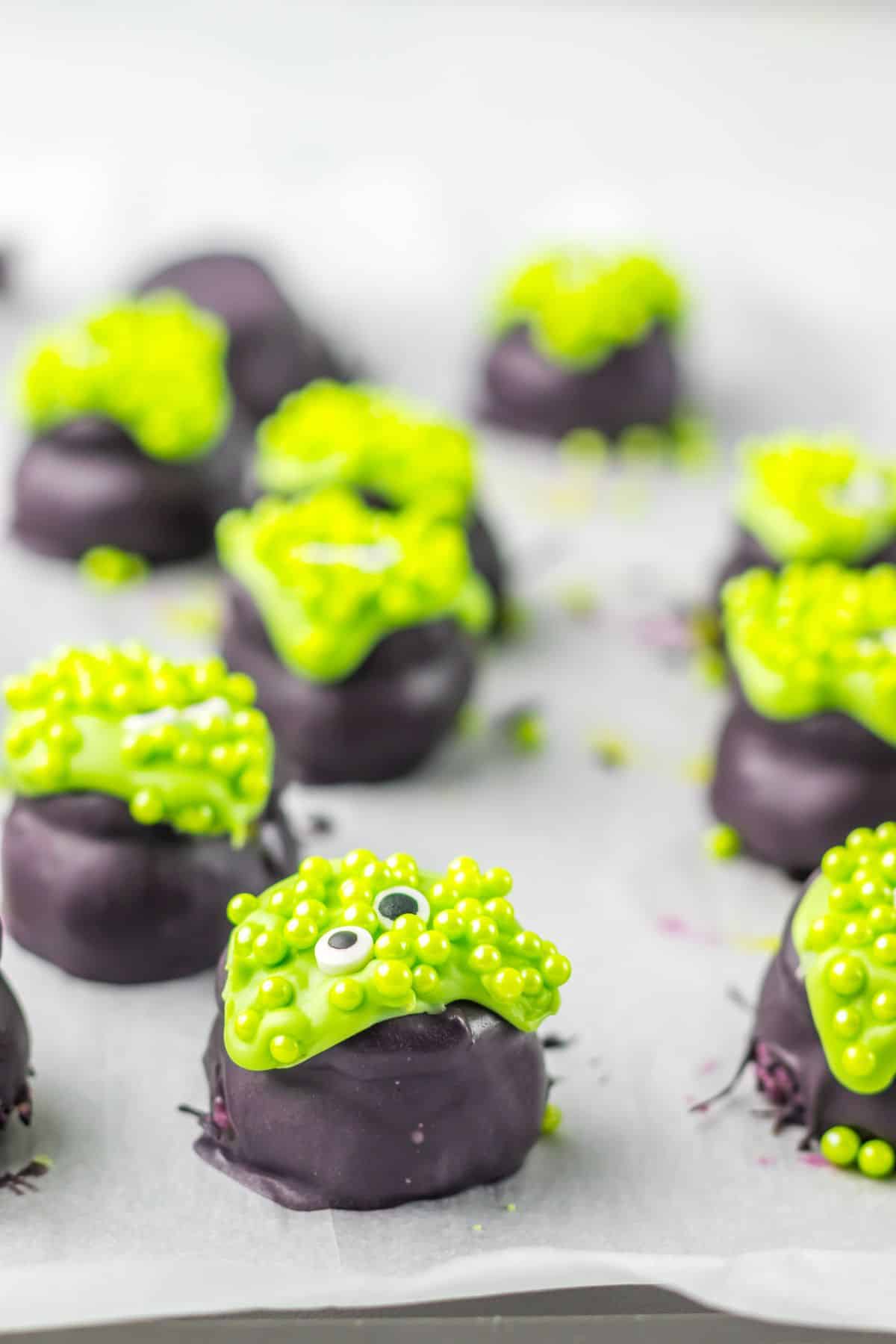 Sprinkles being added to the top of the Cauldren Oreo Truffles.