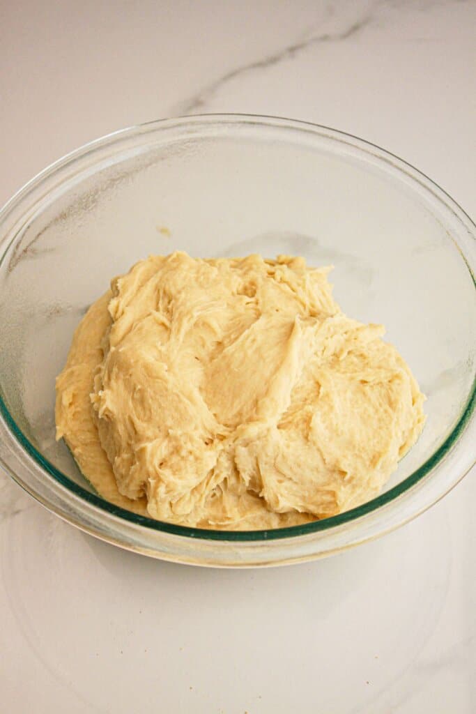 Dough mixed in a glass mixing bowl.