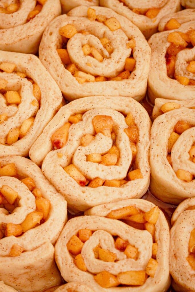 Raw cinnamon rolls in a baking dish ready for the oven.