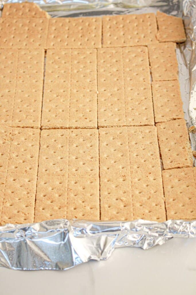 Graham crackers on a foil lined baking sheet.