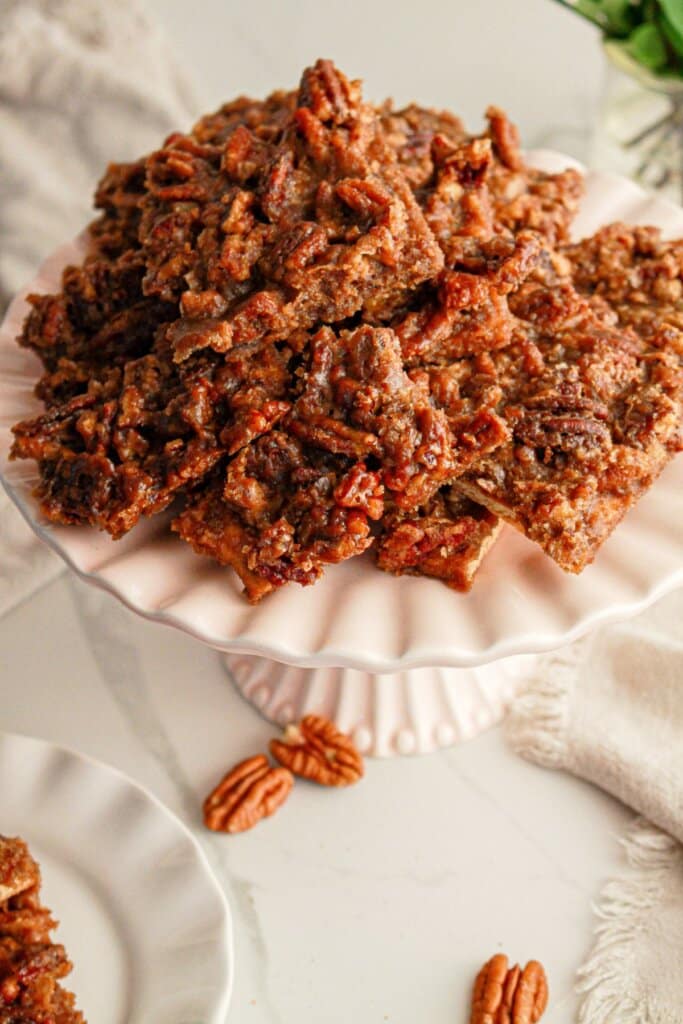 Pecan pie bark on a cake stand.