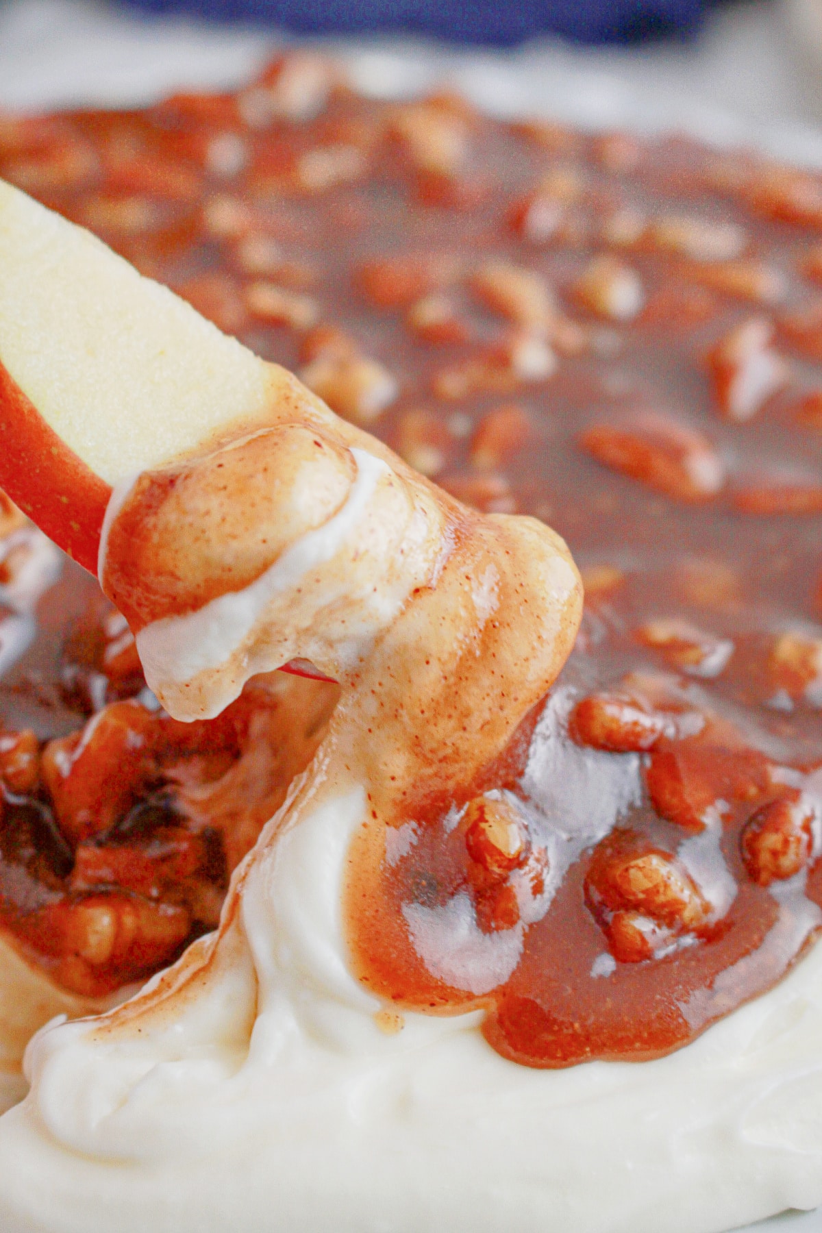 Serving dish full of pecan pie dip on a counter.