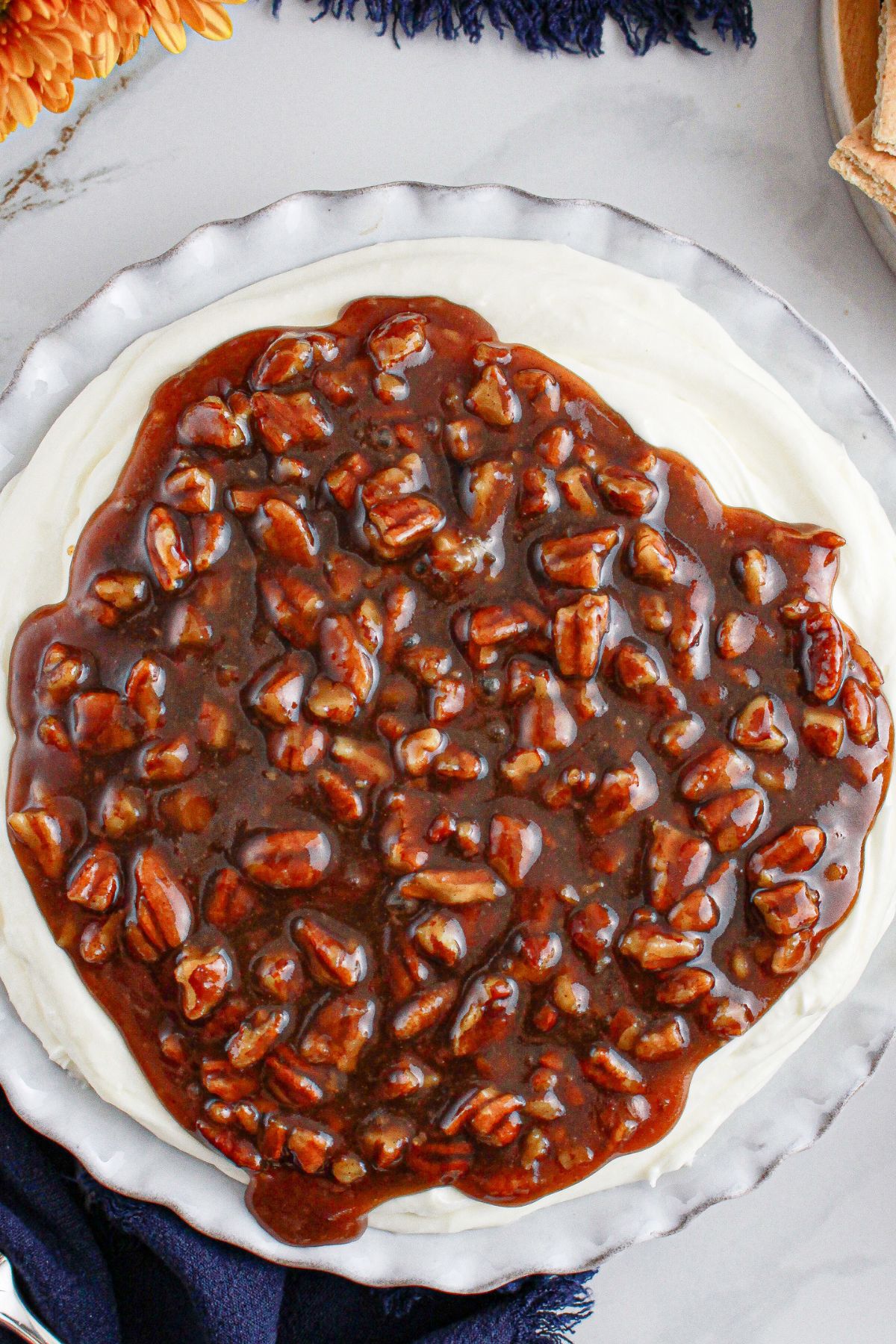 Serving dish full of pecan pie dip on a counter.