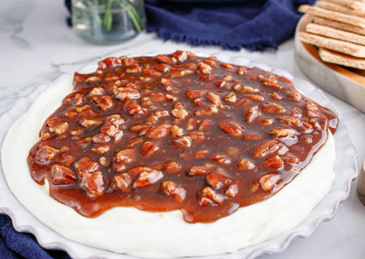 Serving dish full of pecan pie dip on a counter.