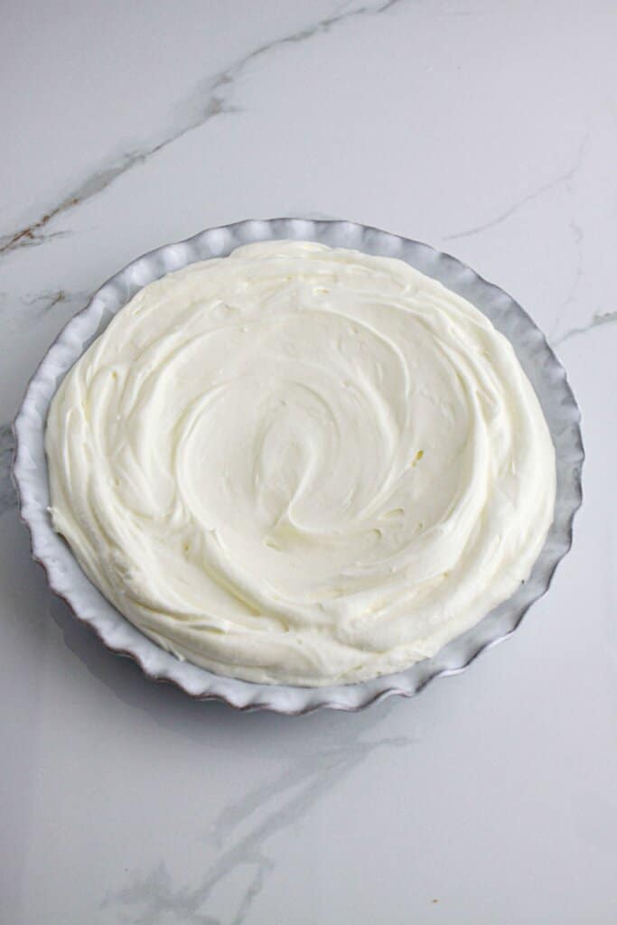 Cream cheese mixture spread into a baking dish.