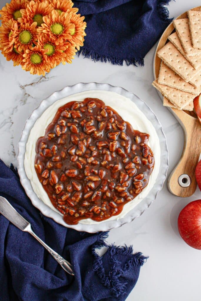 Serving dish full of pecan pie dip on a counter.