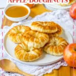 Six puff pastry apple doughnuts on a plate.