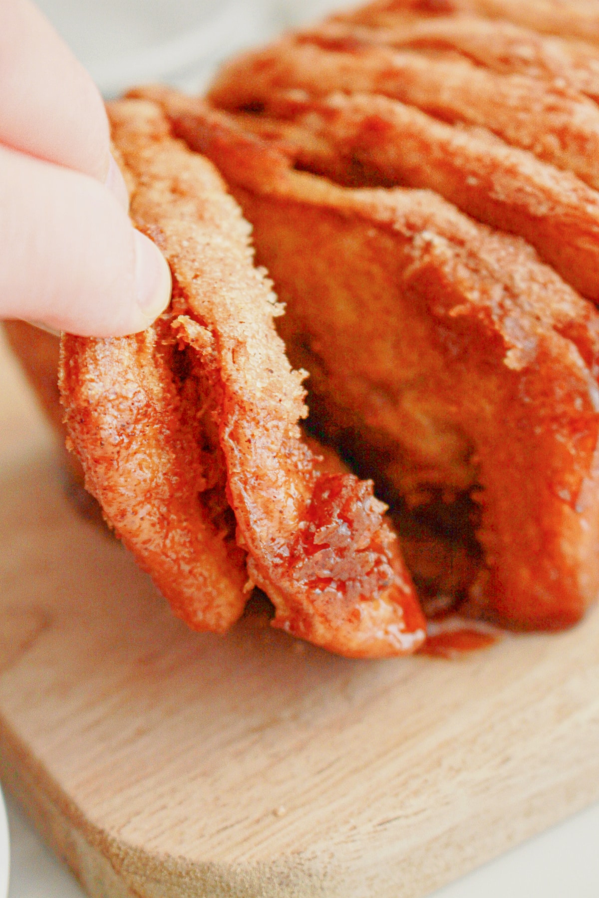 Slices of pumpkin pull apart bread being removed from the stack.