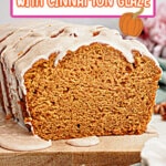 Loaf of pumpkin bread being drizzled with cinnamon glaze on a wooden cutting board with a slice missing.