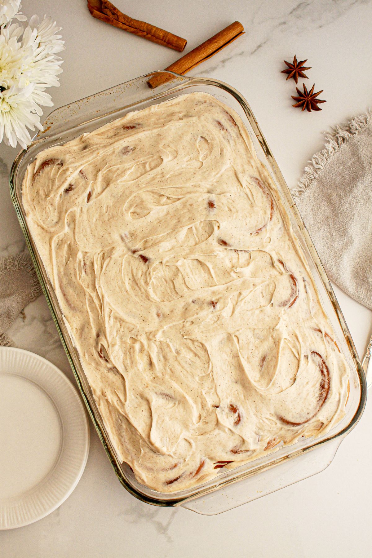 Glass baking dish full of pumpkin cinnamon rolls.