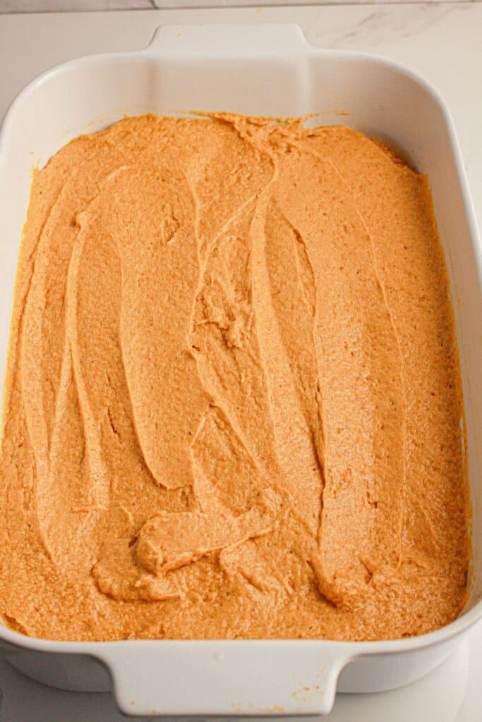 Coffee cake spread into a baking dish.