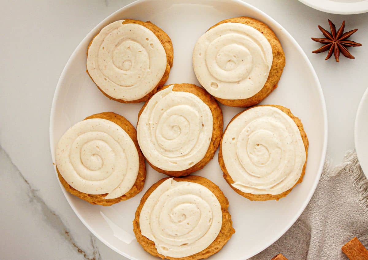 Six pumpkin cookies on a serving platter.