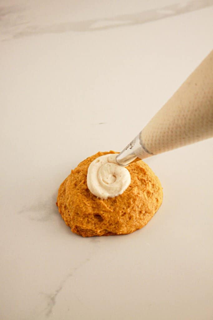 Cream cheese frosting being piped in a circle.