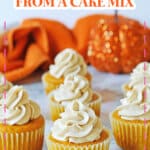 Seven pumpkin cupcakes on a counter.