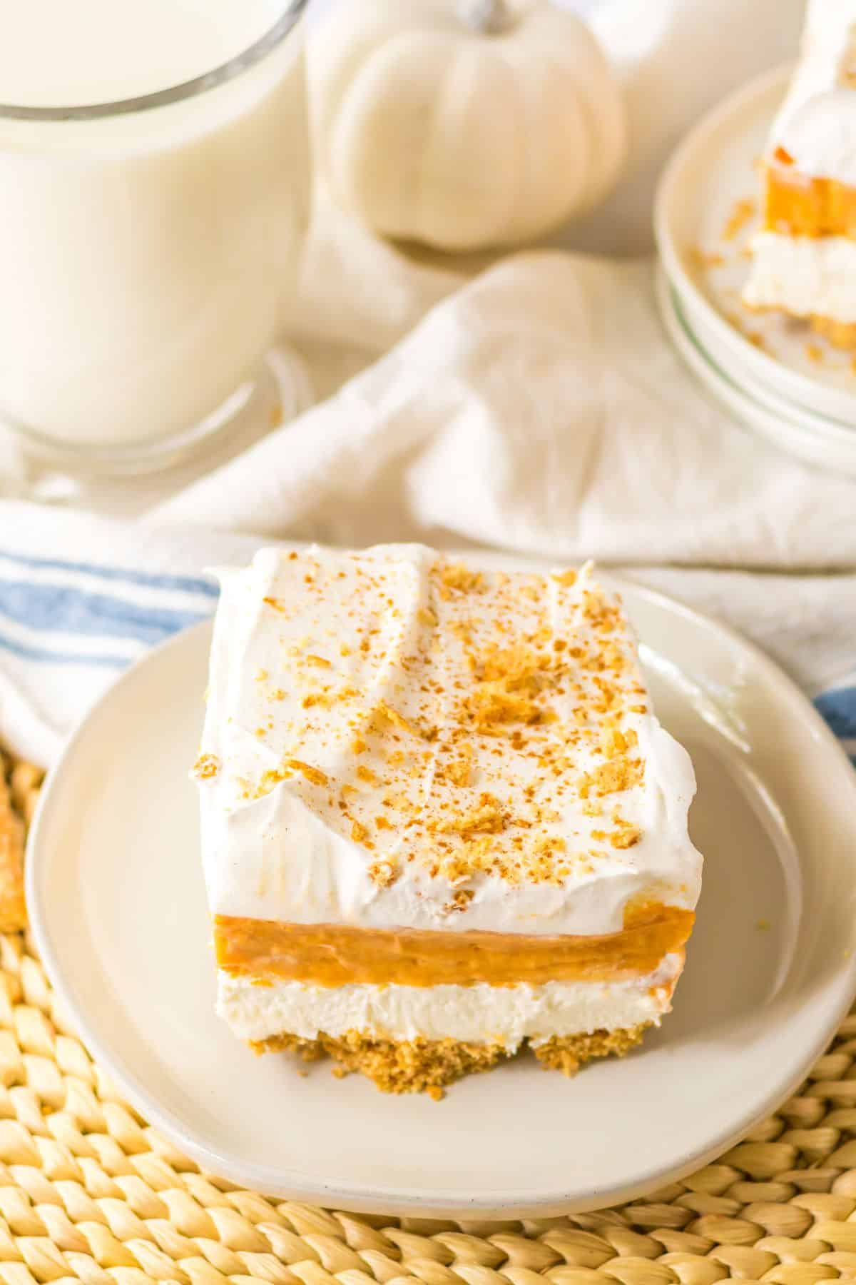Slice of pumpkin lush dessert on a plate.