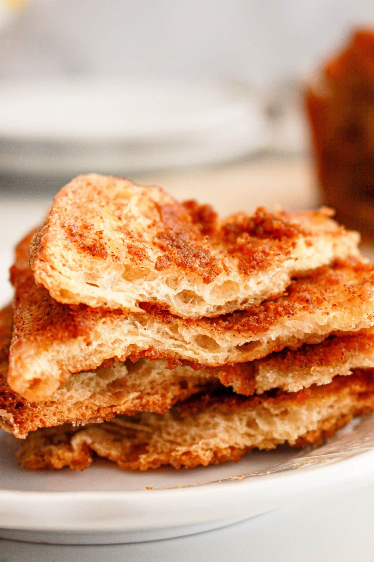 Pieces of pumpkin pull apart bread stacked on a small plate.