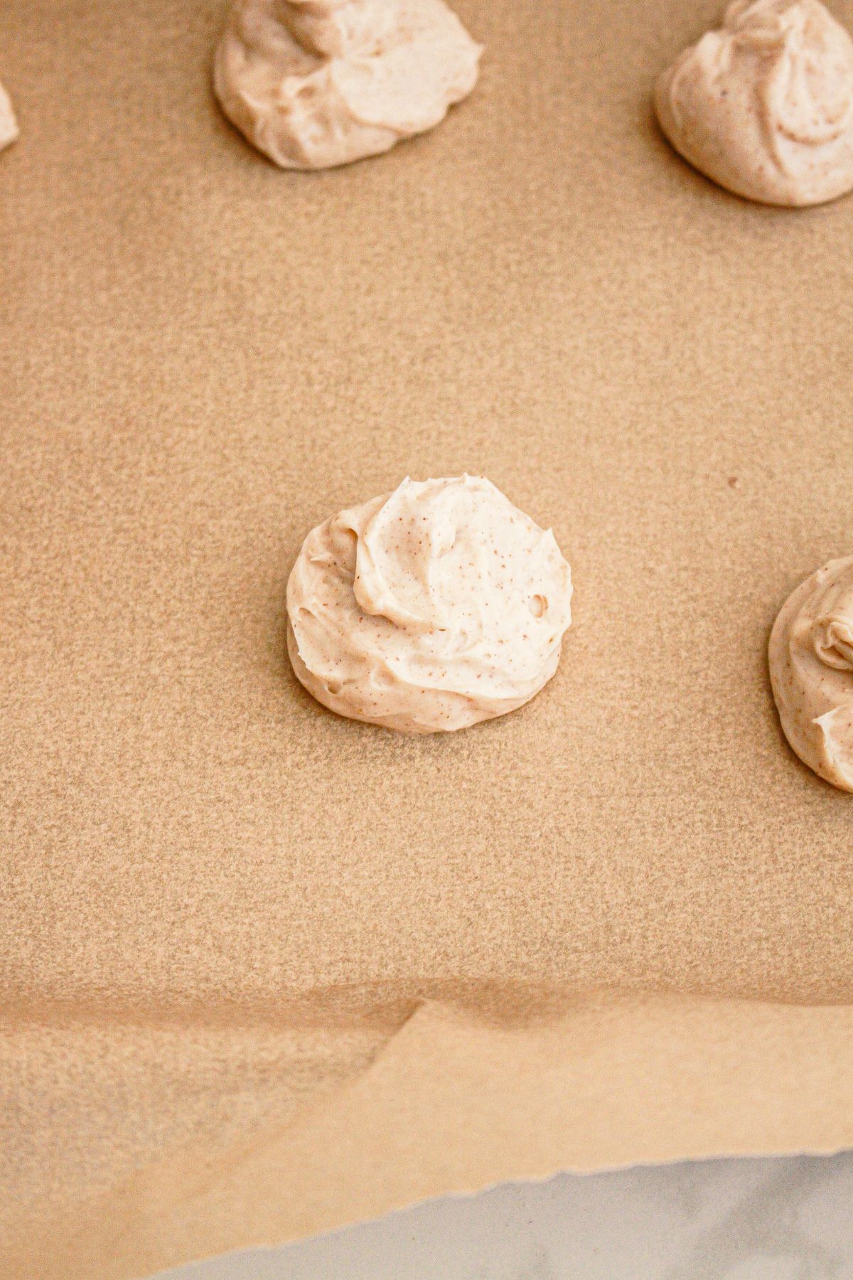 Cheesecake filling being frozen on a parchment lined baking sheet.