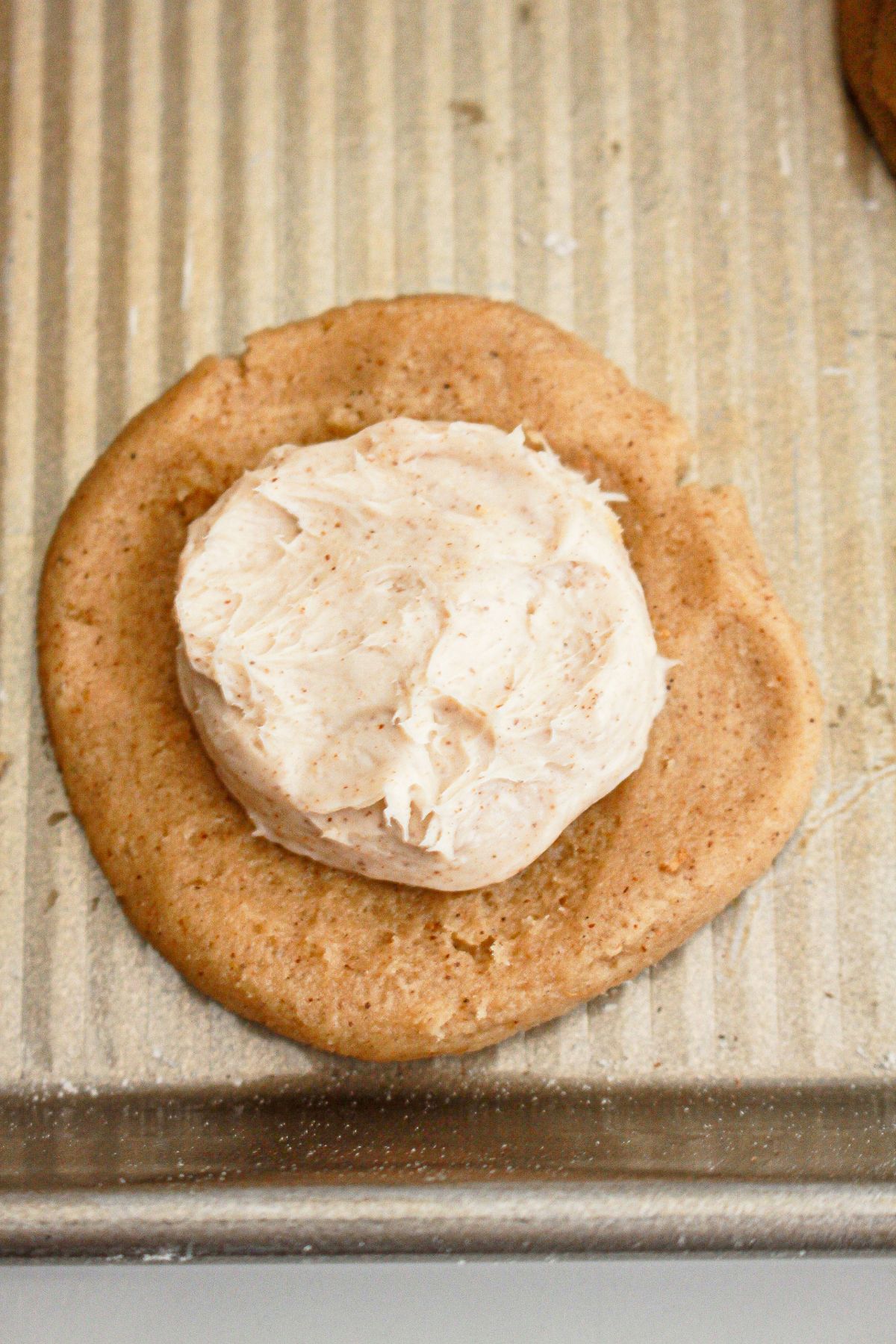 Cheesecake filling being stuffed inside cookie dough.