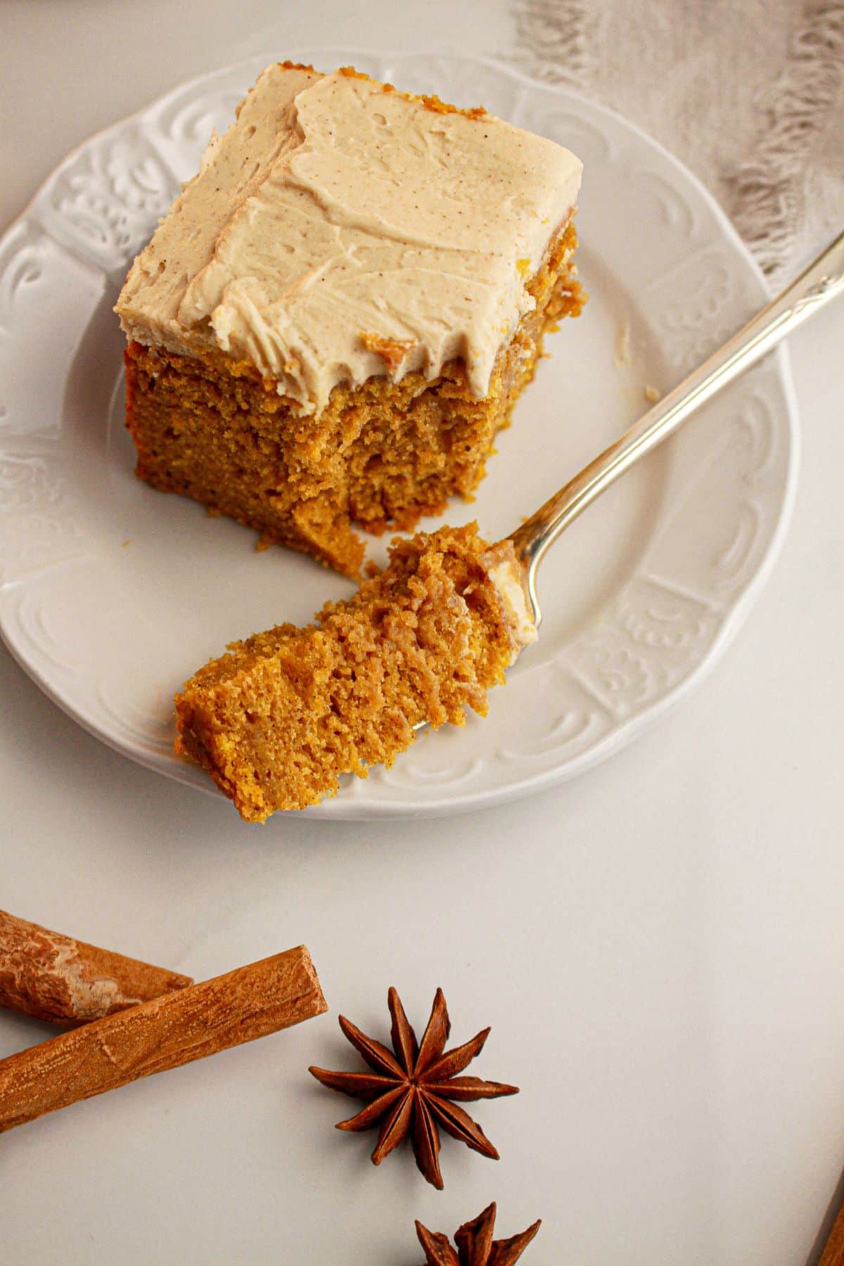 Slice of pumpkin spice latte cake with a bite missing.