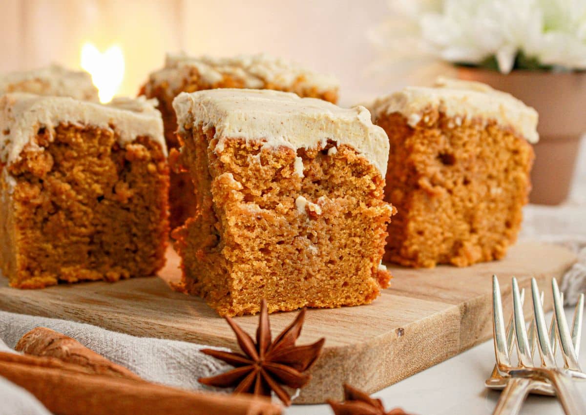Slices of pumpkin spice latte cake on a wooden cutting board.
