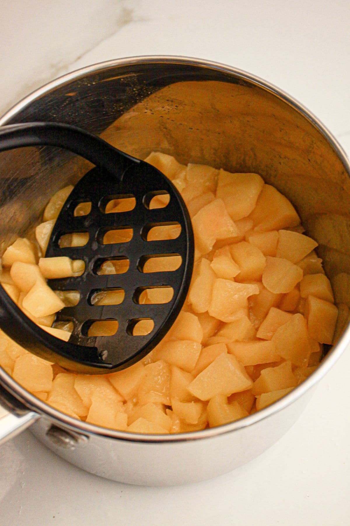Apples mashed in a pan.