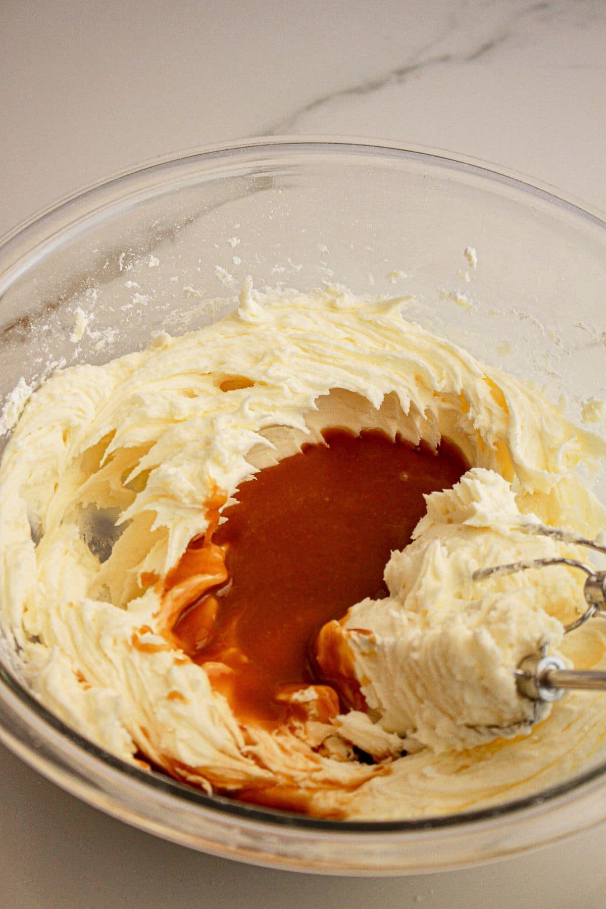 Frosting in a glass mixing bowl.