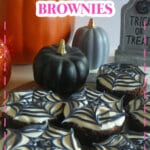 Six spider web brownie on a wooden cutting board.