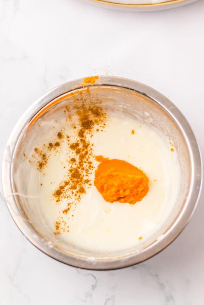 Pumpkin puree and pumpkin pie spice being added to glaze.