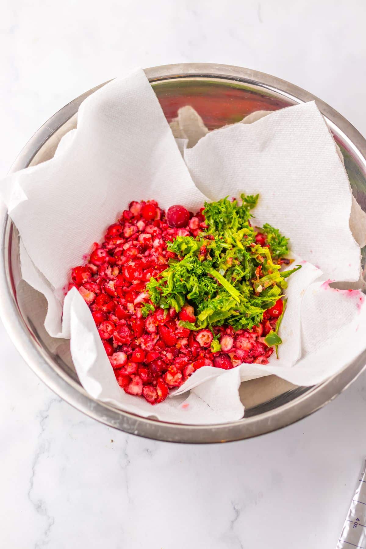 Cranberries being drained in a bowl.