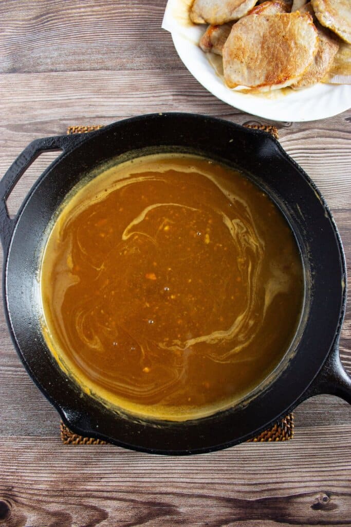 Apple cider sauce in a cast iron skillet.