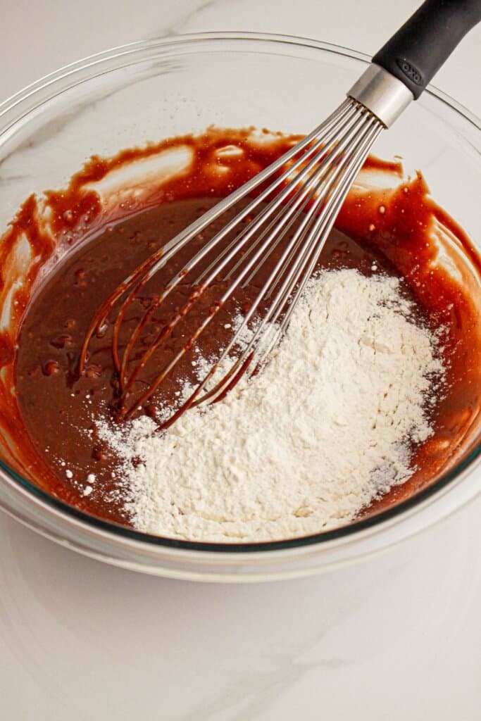 Flour being added to batter.