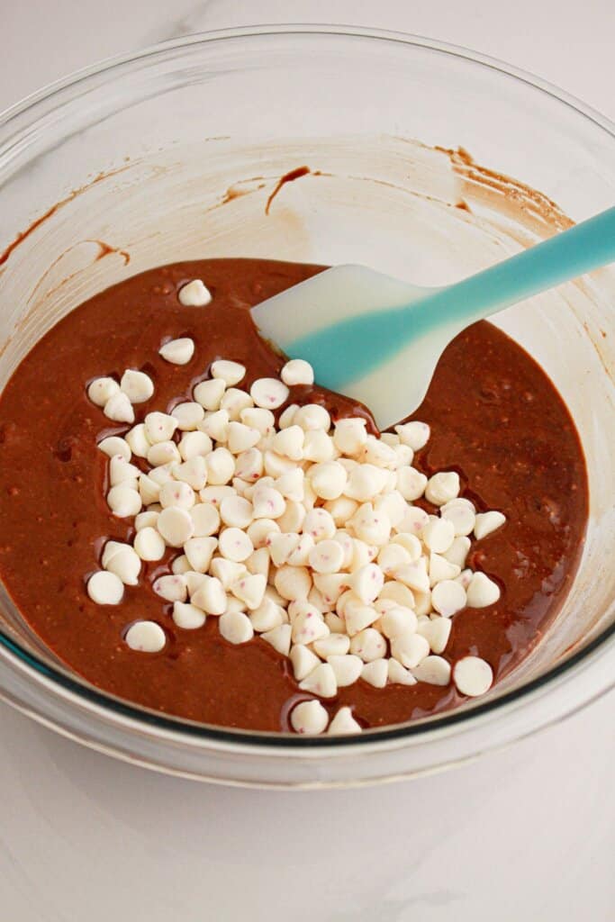 Peppermint chips being mixed into batter.