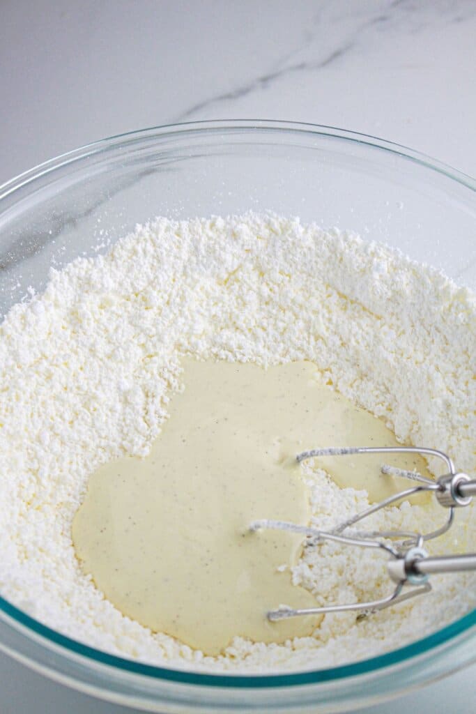 Powdered sugar being added to white chocolate.