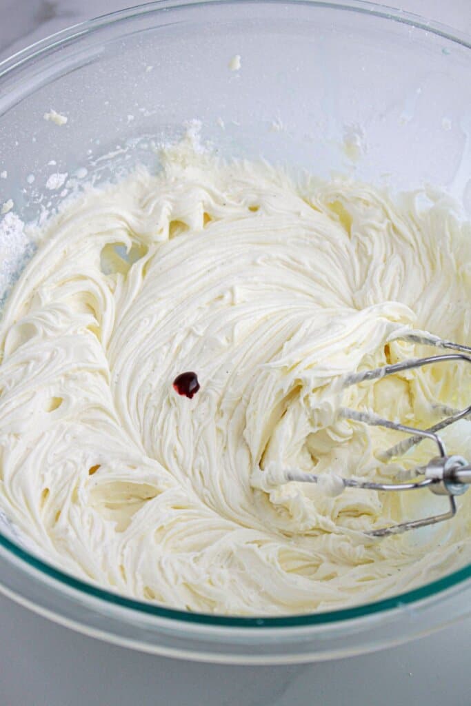 Food coloring being added to frosting.