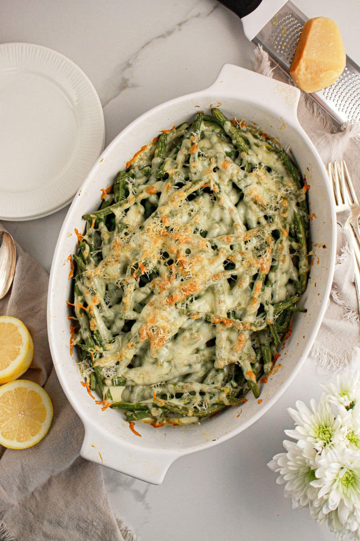 Cheesy baked green beans in a baking dish.