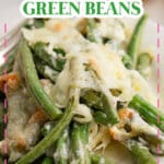 Green beans topped with mozzarella cheese on plate.