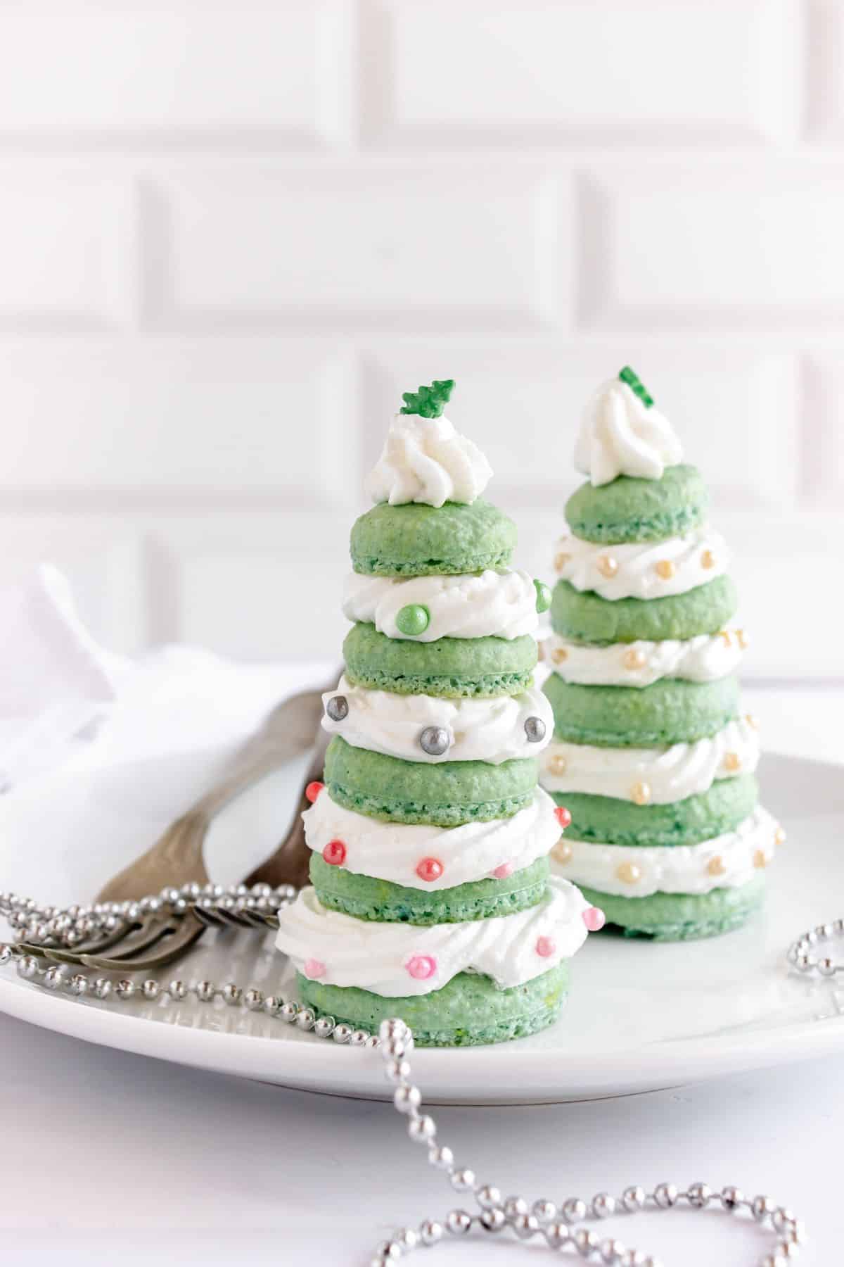 Christmas tree macarons on plate.