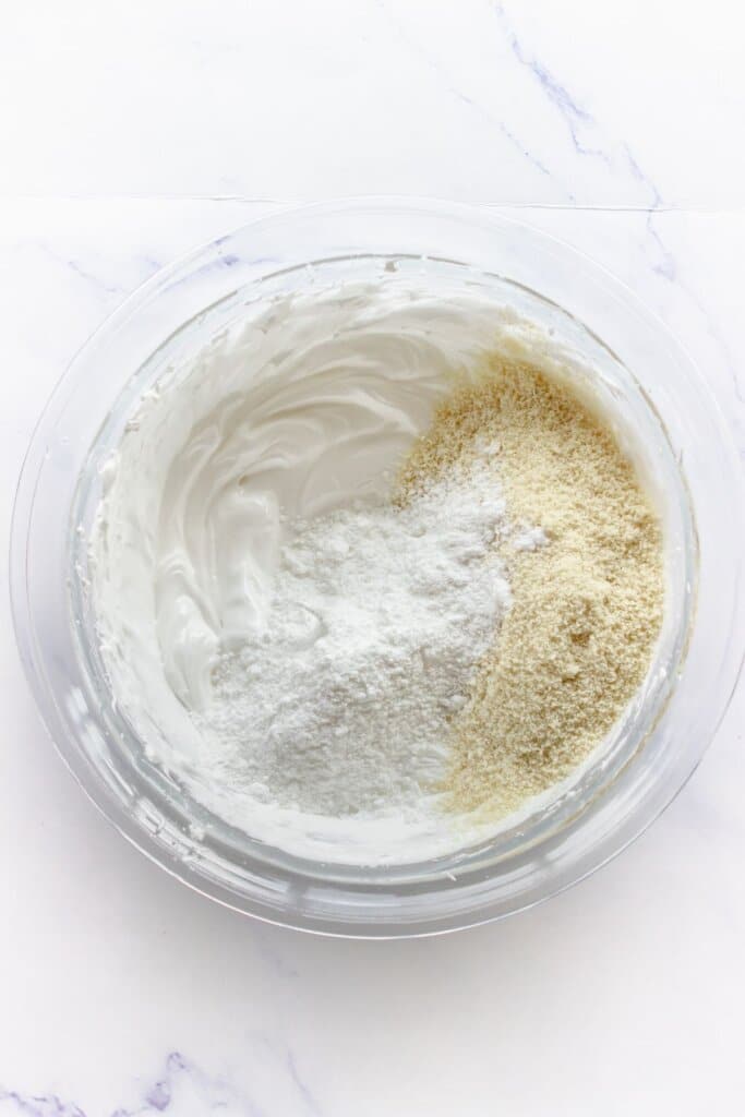 Flour being added to a bowl.