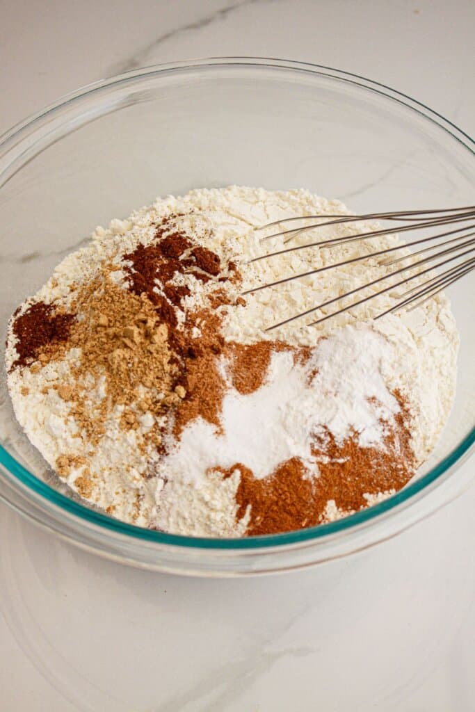 Dry ingredients being mxied in a glass bowl.