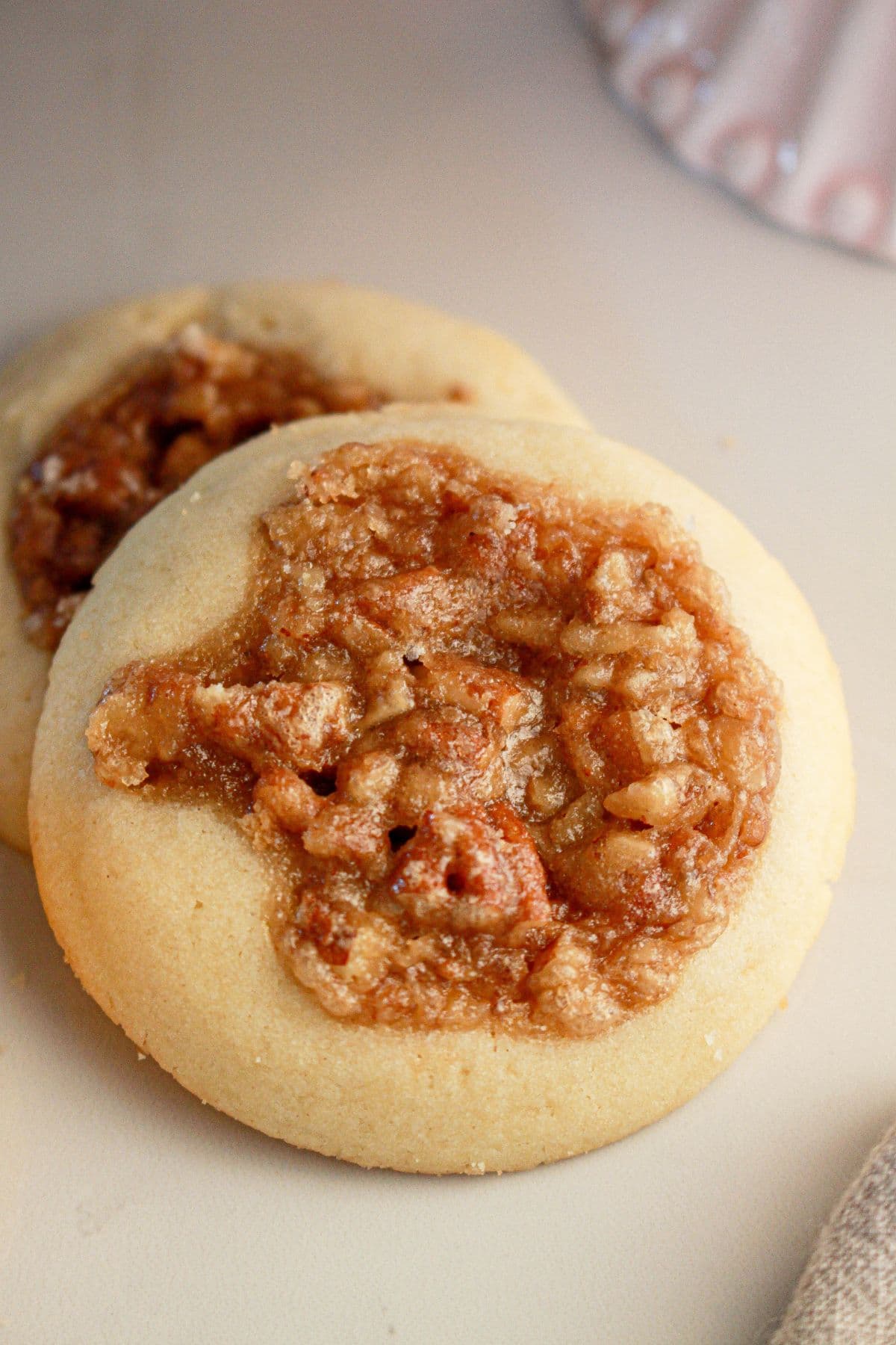Two pecan pie cookies on a counter.