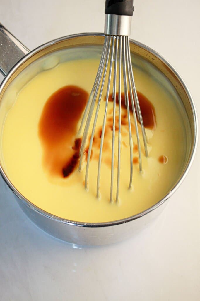 Pudding being cooked in a saucepan.