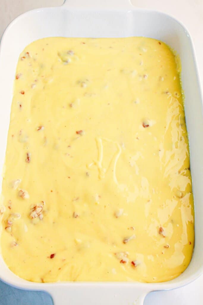 Pudding being spread in baking dish.