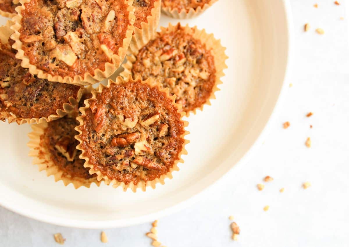 Pecan Pie muffins stacked on a plate.
