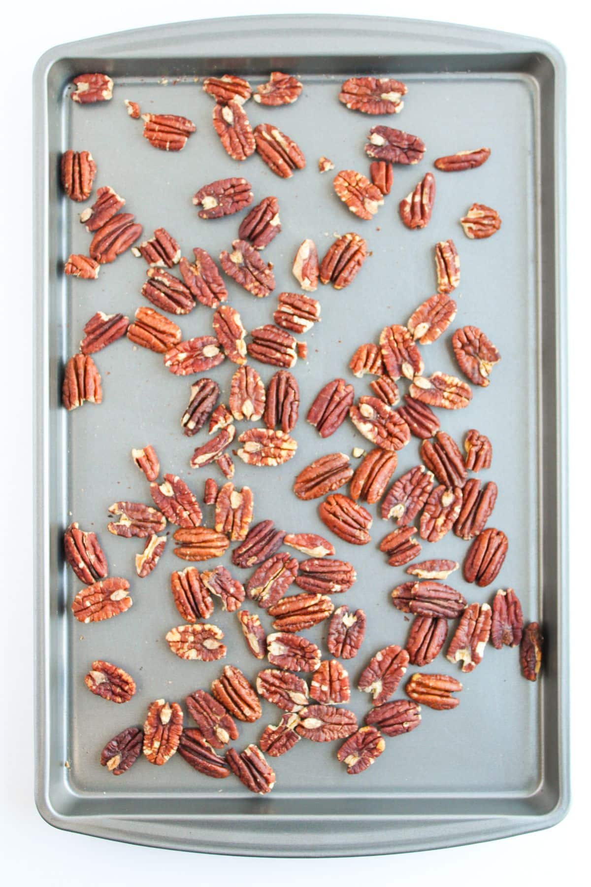 Pecans toasted on a baking sheet.