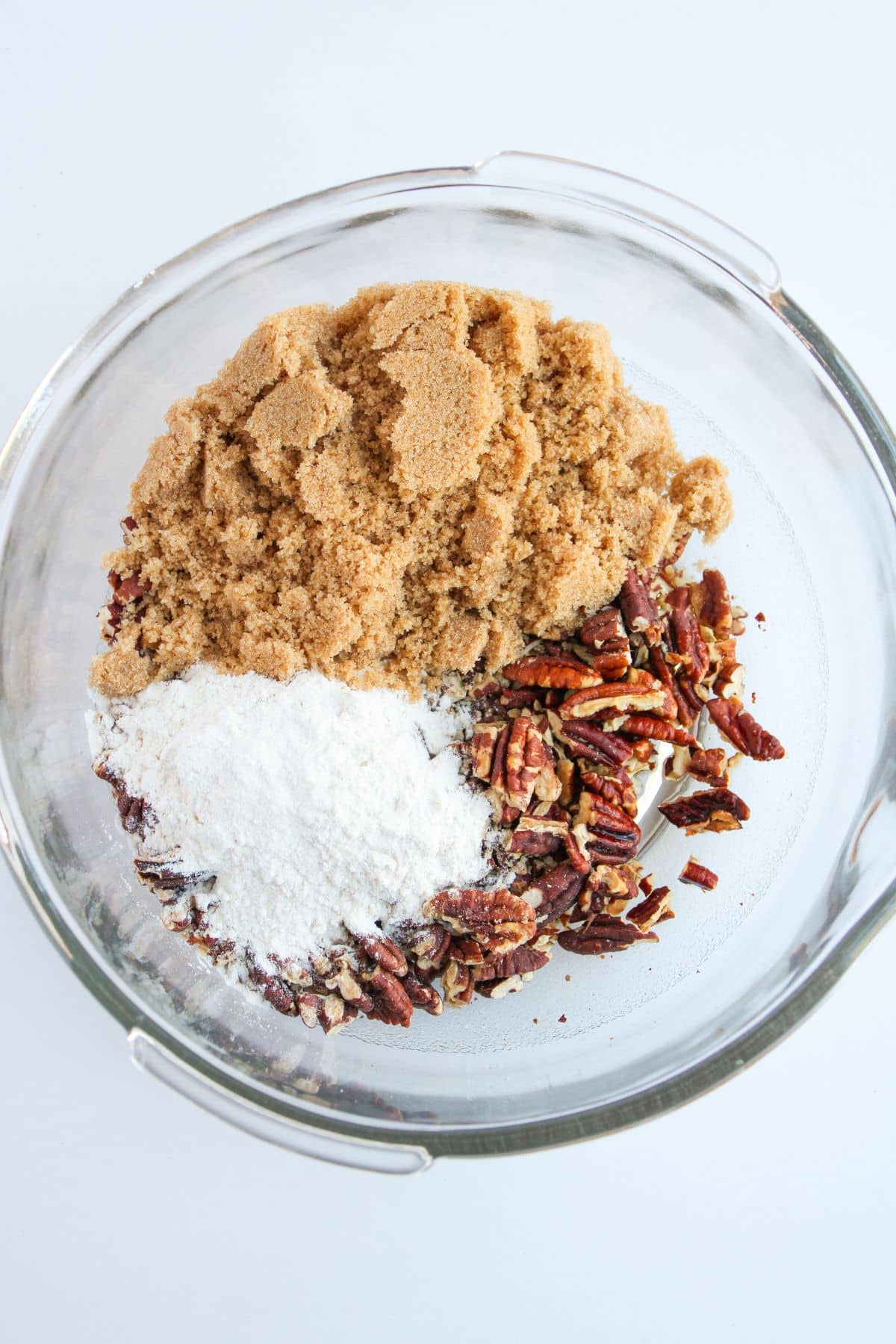 Brown sugar and pecans in a mixing bowl.