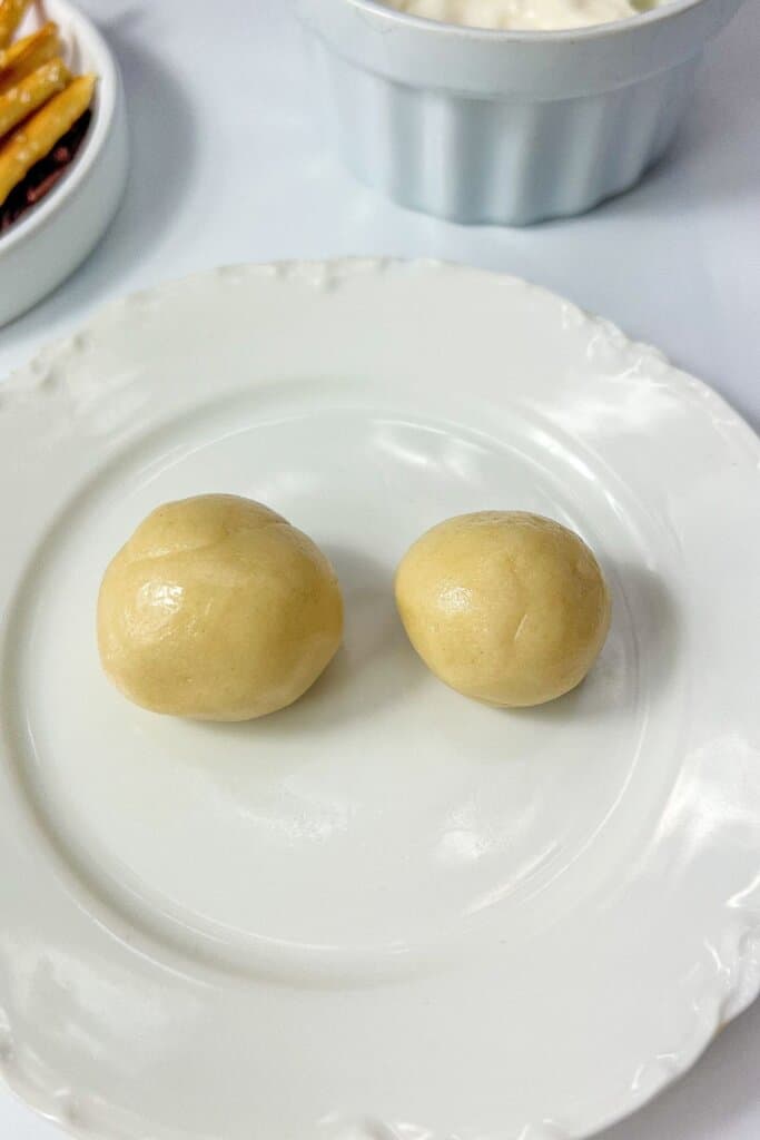 Cookie dough balls on a plate.