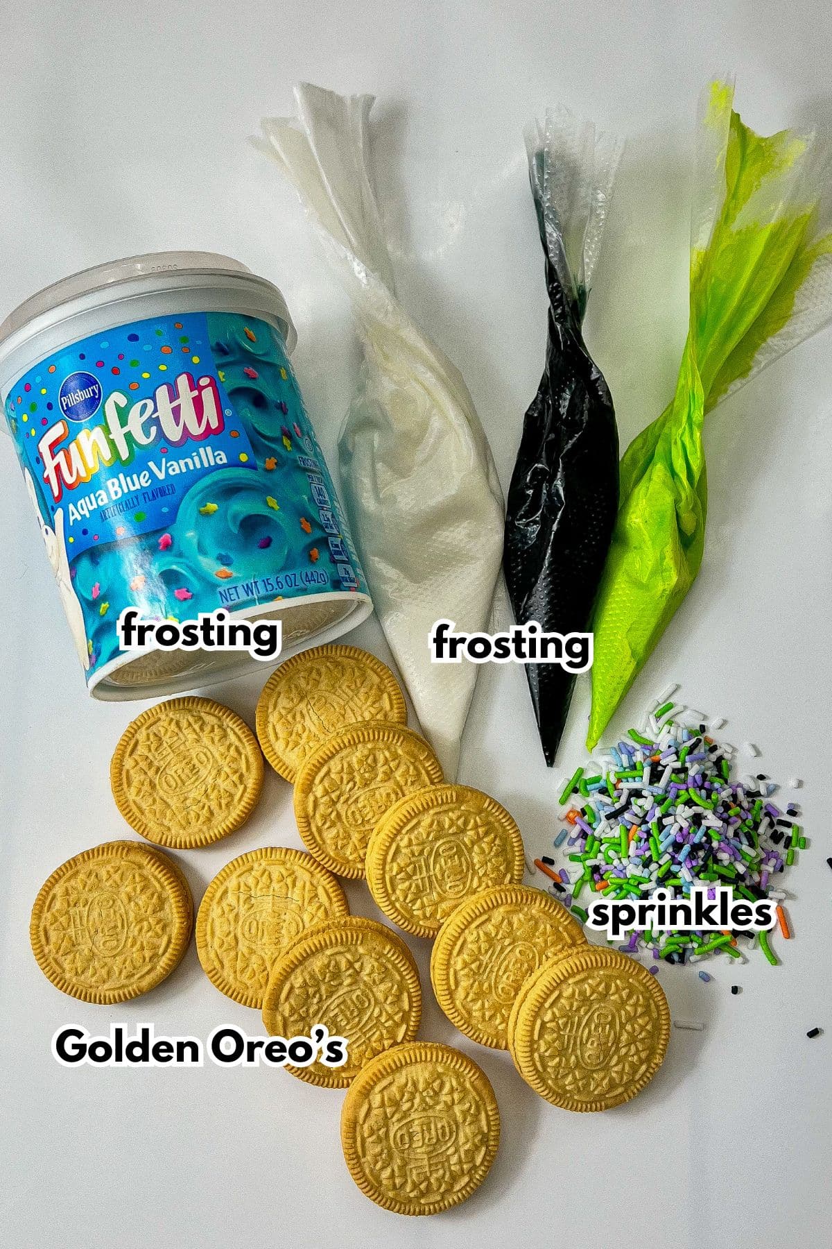 Frosting, Oreos, and sprinkles on a counter.